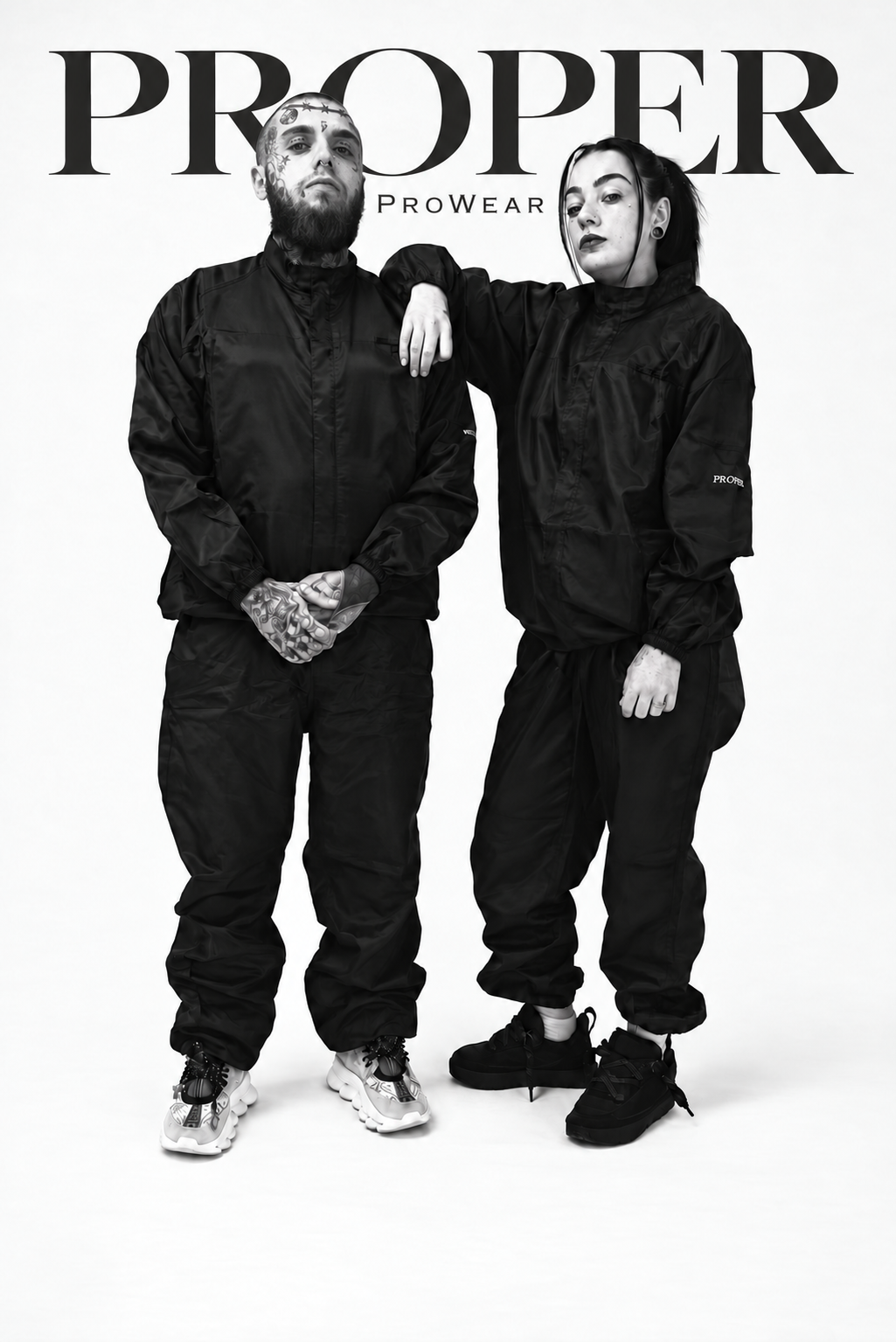 Two models wearing matching black Barber Armour hair-resistant two-piece suits