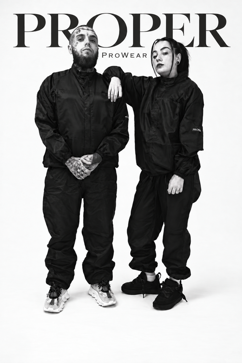 Two models wearing matching black Barber Armour hair-resistant two-piece suits