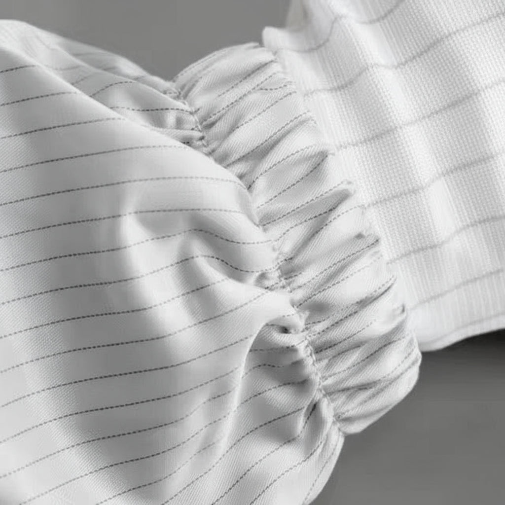 Close-up of a black fabric with a textured pattern on a neutral background